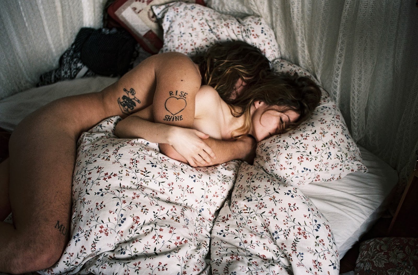 Девушка и мужчина в кровати обнявшись
